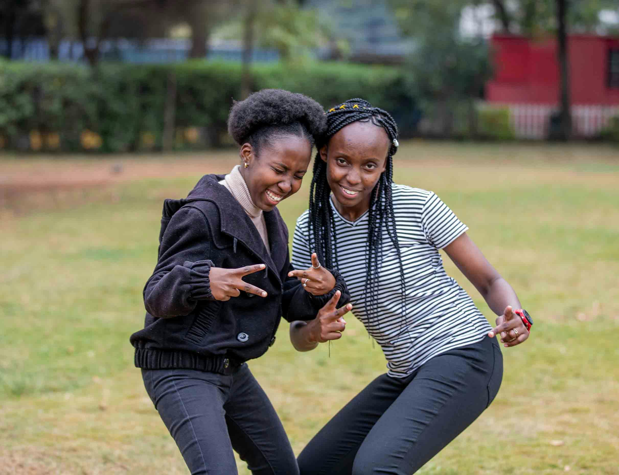 2 black girls wearing jeans posing for the camera