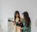 Woman teaching a girl to play ukelele